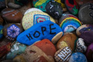 Pebbles painted with the words hope and nhs