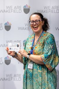 Sarah holding plaque